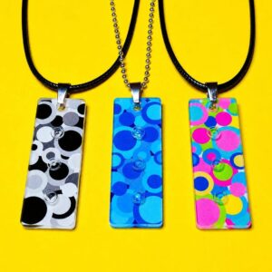 The three different colour variations of the 3 Dot Pendant are shown in the picture