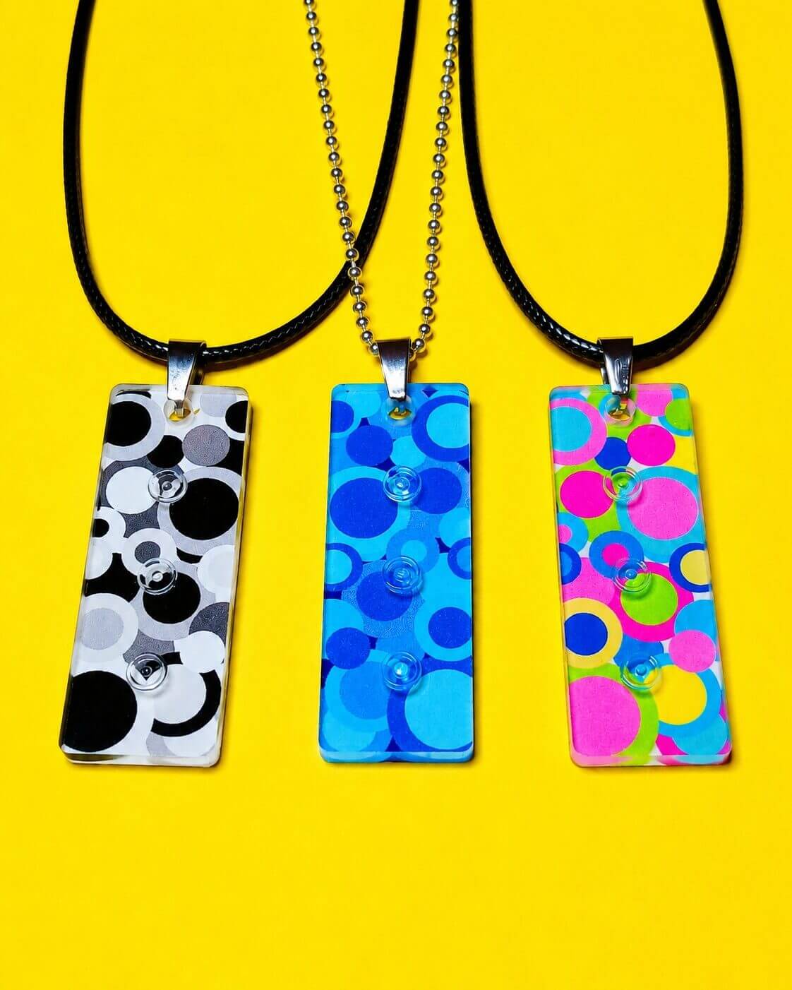 The three different colour variations of the 3 Thoughts Pendant are shown in the picture