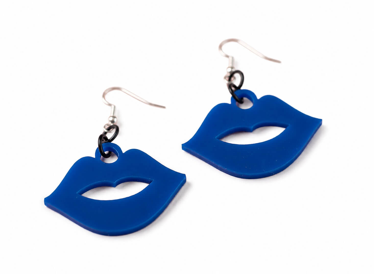 Blue lips earrings against a white background