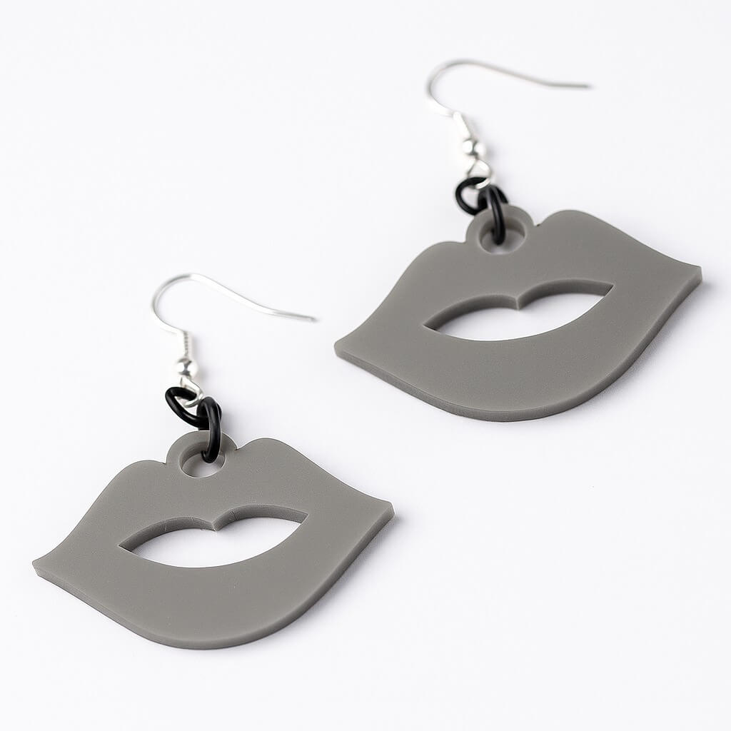 Gray lip-shaped earrings with black accents on a white background