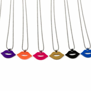 Row of colorful lip-shaped necklaces on white background