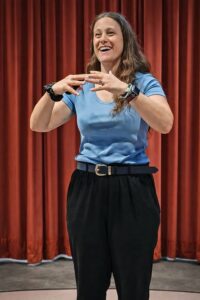 Woman speaking with hands gesturing, possibly at a Connect event