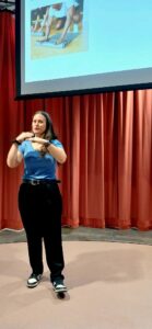 Woman presenting at a Connect event, discussing 'Wish I'd Known