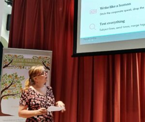 Woman presenting on a screen with text about writing and testing