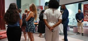 People at a museum exhibit, discussing ideas at Wish I'd Known Connect event.
